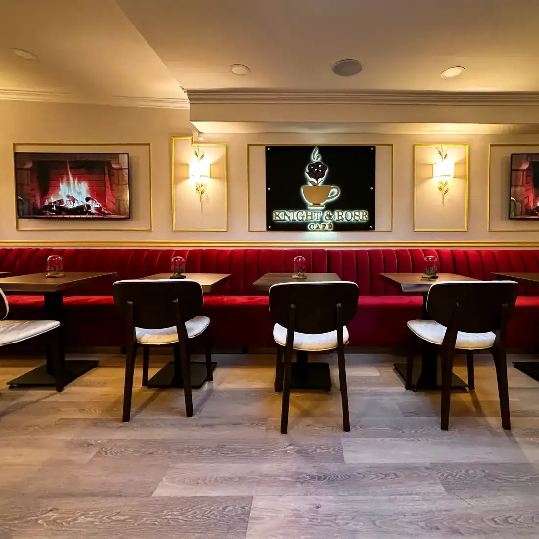 Red velvet banquettes and walnut tables running the length of Knight & Rose Café.